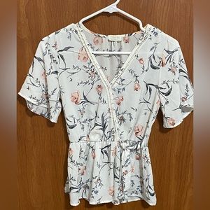 Soft, white floral blouse.